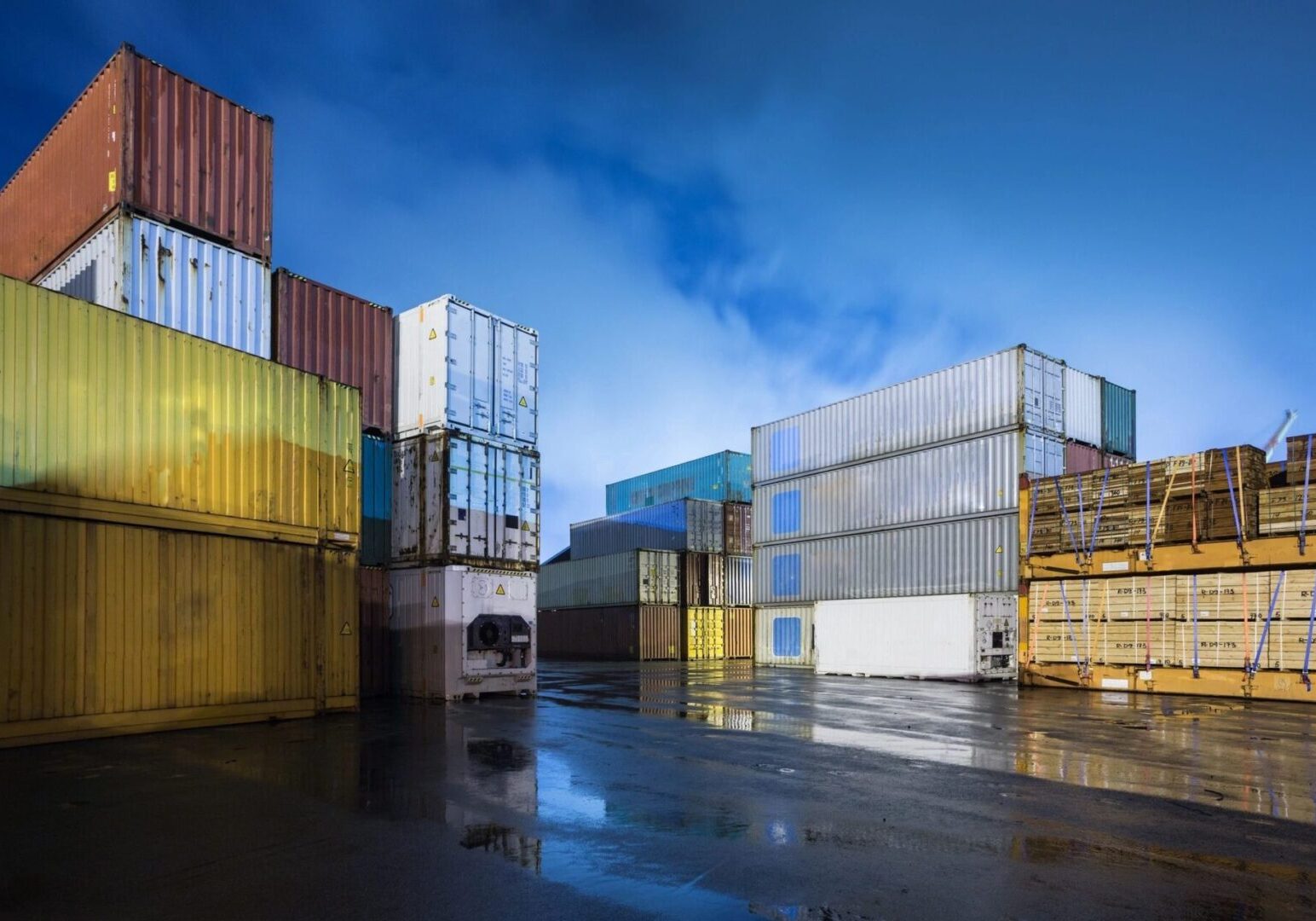 A large group of containers in the rain.