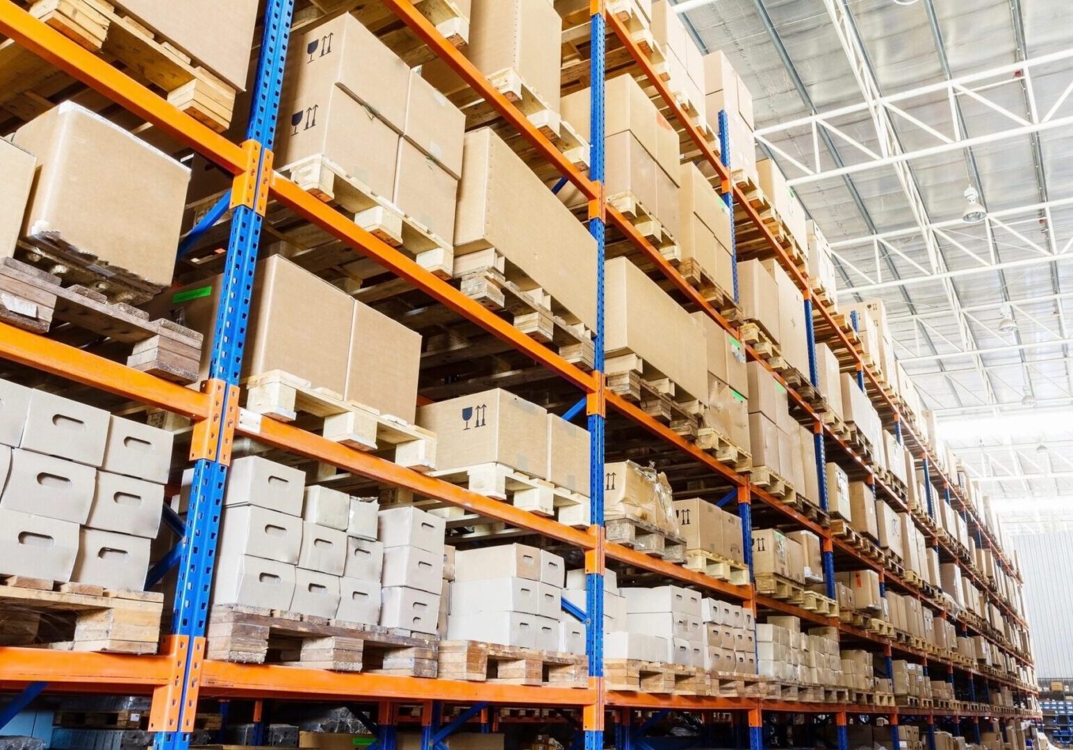 A warehouse filled with lots of boxes on shelves.